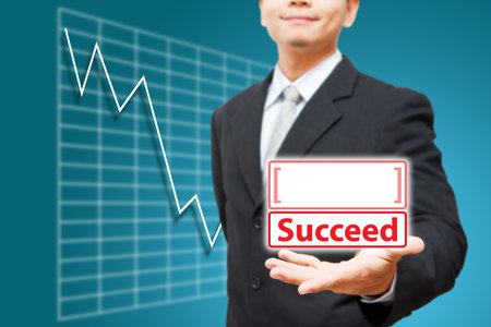 Business man hold Succeed icon on the handの写真素材
