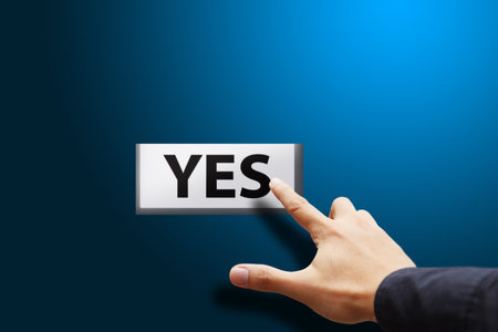 Hand press Yes button の写真素材