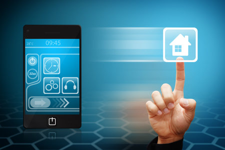 Smart Hand touch the house icon from mobile phone Smart Hand touch the house icon from mobile phone