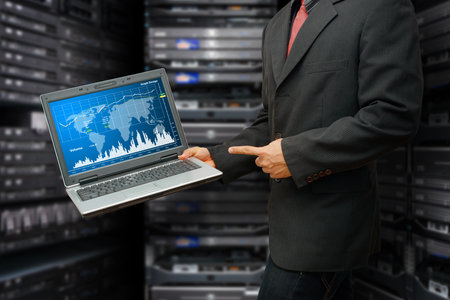Programmer in data center room and graph report