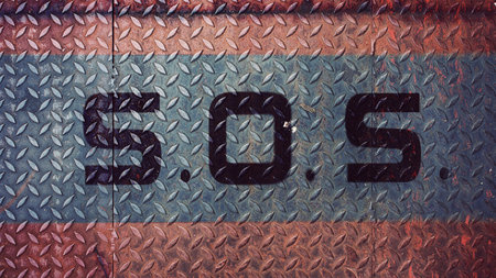 SOS help sign on iron plateの写真素材