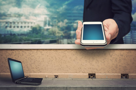 Smart phone and laptop present communication business conceptの写真素材