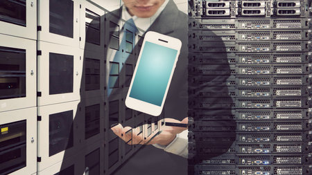 Programmer in data center room for networking computing conceptの写真素材