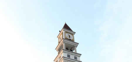 Clock tower and light blue sky background の写真素材