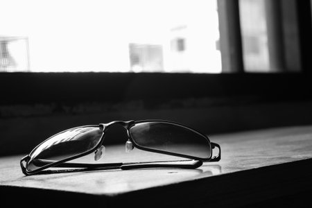 Sunglasses on table, black and white toneの写真素材