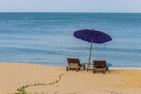 Chairs and umbrella on the beach, Huahin, Thailandの写真素材