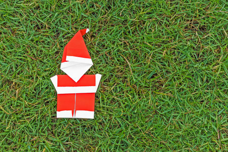 Origami santa claus on grassの写真素材