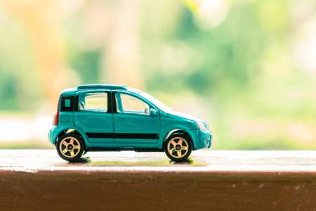 Hatchback car toy on wooden terrace