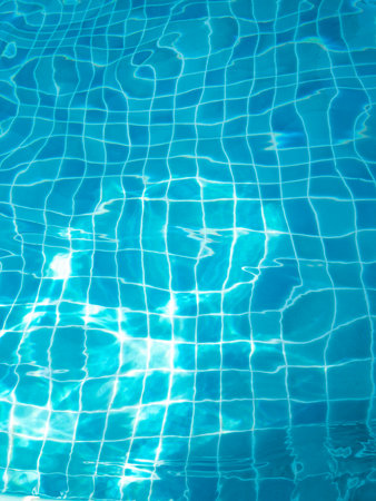 The water in the swimming pool with light reflecting the bottom of the pool is a blue checkerboard...