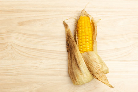 Burnt corn cooked  on wooden background.の写真素材
