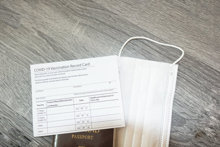 Tourists presenting passports and Vaccination Record card. Covid-19 vaccinated travel concept.の写真素材
