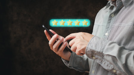 a businessman use smartphone select on the five star to give satisfaction in service.rating very impressed.Customer service and Satisfaction concept.の写真素材
