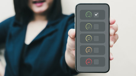 person hand using smartphone give happy Smiley face icon and five star symbol to increase rating of product and service concept, Customer service experience and business satisfaction survey.の写真素材