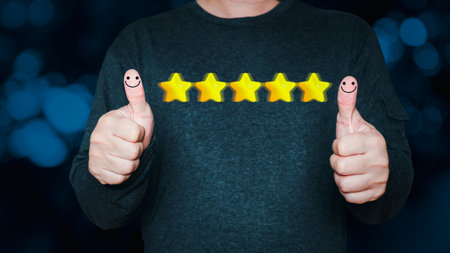 a businessman thumbs up on the happy Smiley face icon and five star to give satisfaction in...
