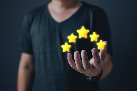 hand of customer or client holding the stars to complete five stars with copy space.Service...