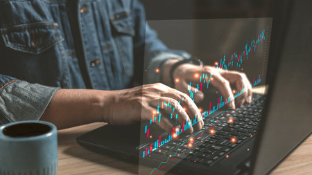 man use laptop graphs and business progress and analyze financial and investment. Use technology to...