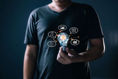 man hold bot icon and command prompt ai chat ability to create photos,compose song and novels,make videos,stock trading,ai disruption in many professions.Digital Artificial Intelligence(AI) technologyの写真素材