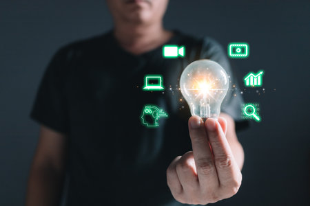 Man holding light blub with icons, Marketers education, research, analyze media video streaming...