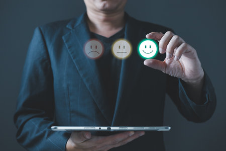 a businessman choose the virtual screen on the happy smile face icon to give satisfaction in service.rating very impressed.customer review service and Satisfaction conceptの写真素材