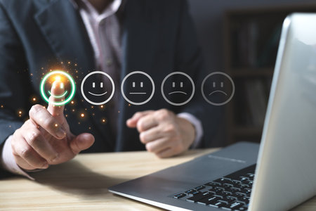 a businessman choose the virtual screen on the happy smile face icon to give satisfaction in service.rating very impressed.customer review service and Satisfaction conceptの写真素材
