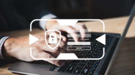 Businessman protecting personal data on laptop with virtual screen interfaces.Cybersecurity and...