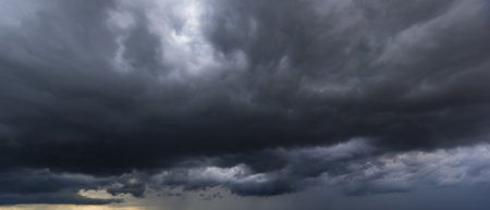 The dark sky with heavy clouds converging and a violent storm before the rain. Bad or moody weather...