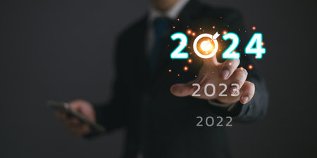 Businessmen touch target 2024 and progress of business and analyze financial, and investment.Use technology to plan strategy to success goals and growth.online business, e-commerce, online marketing.の写真素材