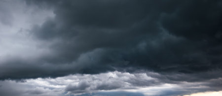 The dark sky with heavy clouds converging and a violent storm before the rain. Bad or moody weather...