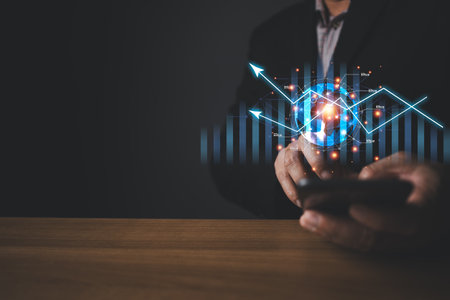 A person holding global and graph stock to plan in e-business, the use of online digital network technology in business, buying and selling commerce online digital marketplaceの写真素材