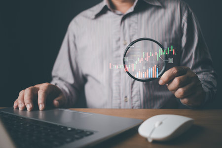 man use laptop graphs and progress of business and analyze financial,and investment.Use technology to plan strategy to success goals and growth stock.online business,e-commerce,online marketing.の写真素材