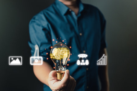 person hand holding power lightbulb and pretend to think. Marketers education, research, analyze media video streaming content creation and online marketing strategies to grow their digital business.の写真素材