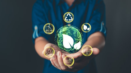 The image showcases a green planet surrounded by icons of sustainable development, highlighting environmental awareness, green energy, and the importance of recycle practices for a better future.の写真素材