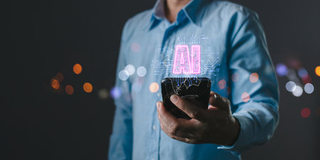 A person holds a smartphone with AI intelligence displayed as a glowing hologram, symbolizing...