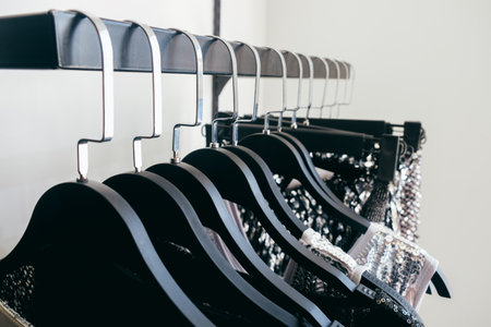 Black metal hangers for outerwear in rhinestones, hang in a row in the store.の写真素材