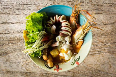 Seafood noodle on wood tableの写真素材