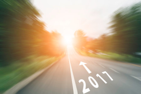 arrow line and 2017 on speed road with sunlight, motion blur effect