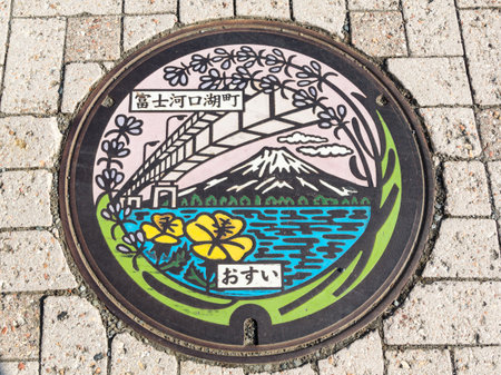 KAWAGUCHIKO, Japan - October 24, 2015 : Mt. Fuji, bridge and the lake on manhole cover of Kawaguchiko lake in Yamanashi, Japan.のeditorial素材
