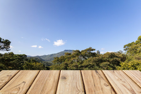 wood table with mountain and blue sky viewの写真素材