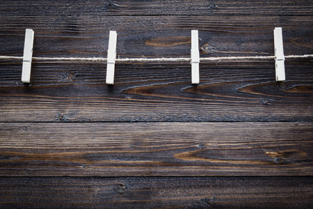 wood cloth peg and hemp rope on brown plank background,dark toneの写真素材