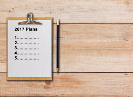 2017 plans on paper clipboard and pencil on wood backgroundの写真素材