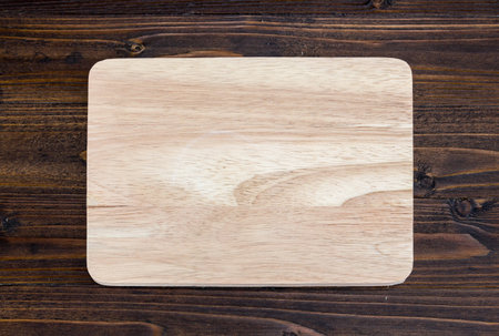 wooden cutting board on wood table for background