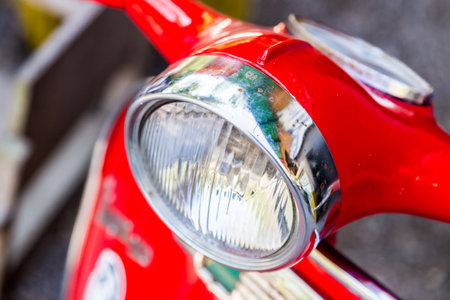 headlight of  red motorcycle, close upの写真素材