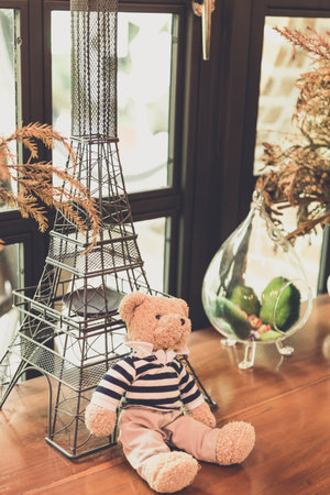 the bear doll sitting on wood table, vintage toneの写真素材