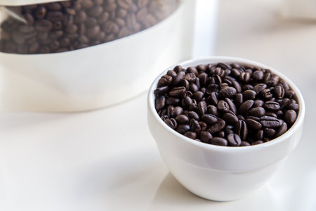 roasted coffee bean in a white cup