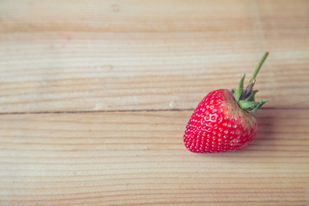 fresh ripe strawberry on wooden backgroundの写真素材