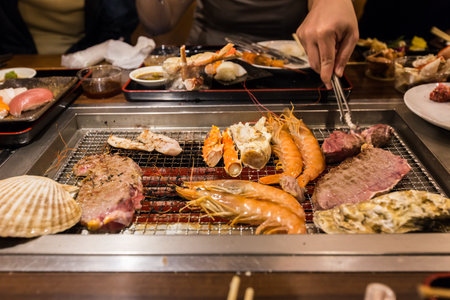 seafood  and meat grilled on electric stoveの写真素材
