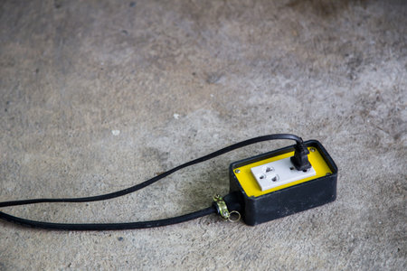 plug and portable socket on the concrete floorの写真素材