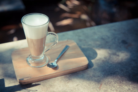 hot latte coffee on wood plateの写真素材