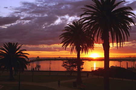 Sun setting over the ocean at St Kilda Pier, Melbourne, Australiaの写真素材