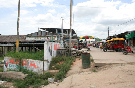 Iquitos, Peru - October 20, 2010: Market stalls and shops line the streets of Iquitos port, Peru, South Americaのeditorial素材